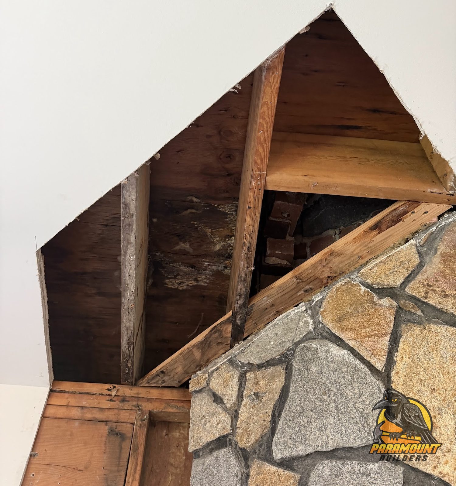 Hidden water damage opened up around a chimney