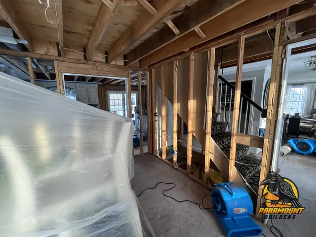 Interior wall opened to studs with air mover on subfloor - Reconstruction, dining room in progress, South Windsor, CT