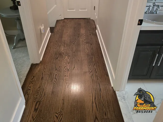 Finished hallway hardwood leading to new tiled bathroom floor - Reconstruction, home after, South Windsor, CT