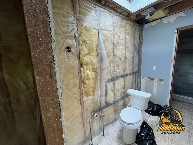 Stripped bathroom wall with vapor barrier, insulation and bare subfloor - Reconstruction, home dried and opened, South Glastonbury, CT
