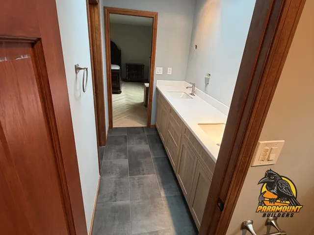 Finished bathroom hallway with new gray tile floor and double vanity - Reconstruction, home finished, South Glastonbury, CT