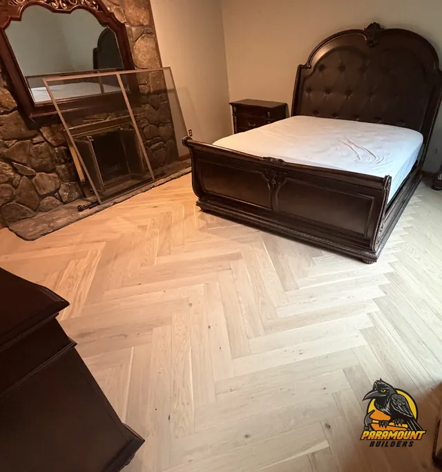 Herringbone wood floor spanning bedroom toward stone fireplace - Reconstruction, home finished, South Glastonbury, CT