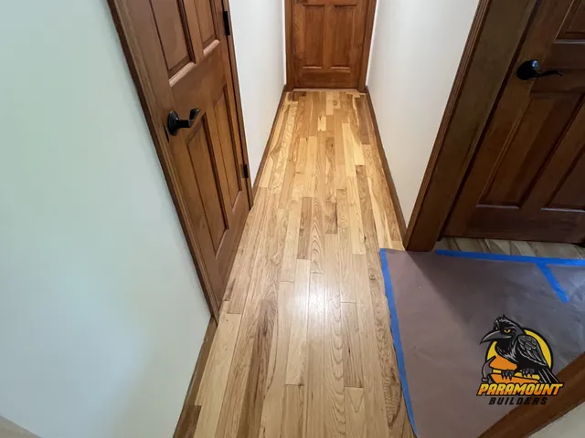 Newly installed hardwood hallway floor with protective paper taped down - Reconstruction, home in progress, South Glastonbury, CT