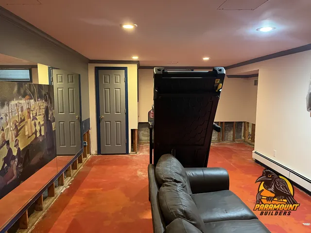 Hallway with wood-look plank flooring beside a black stair railing - Water damage restoration, home finished, Bridgeport, CT