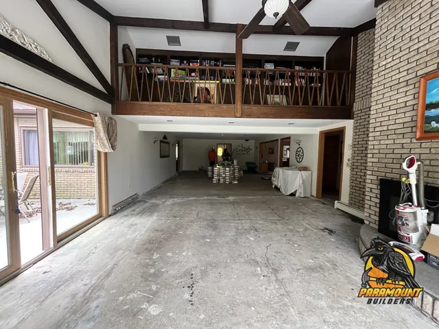 Room stripped to concrete slab with flooring bundles staged - Water damage restoration, home in progress, Burlington, CT